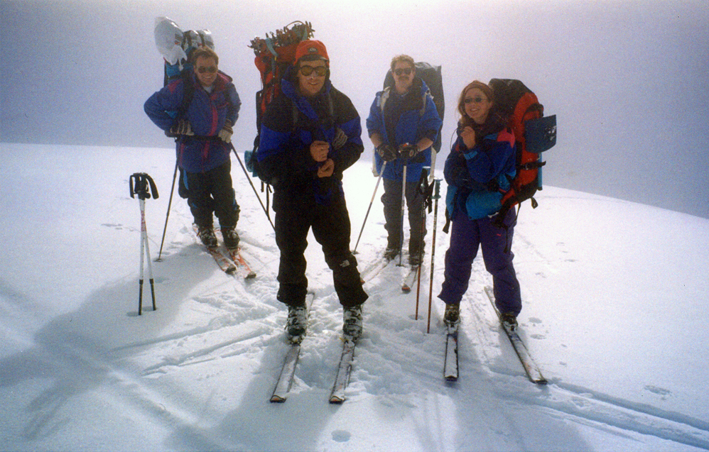 Skiers emerging from whiteout